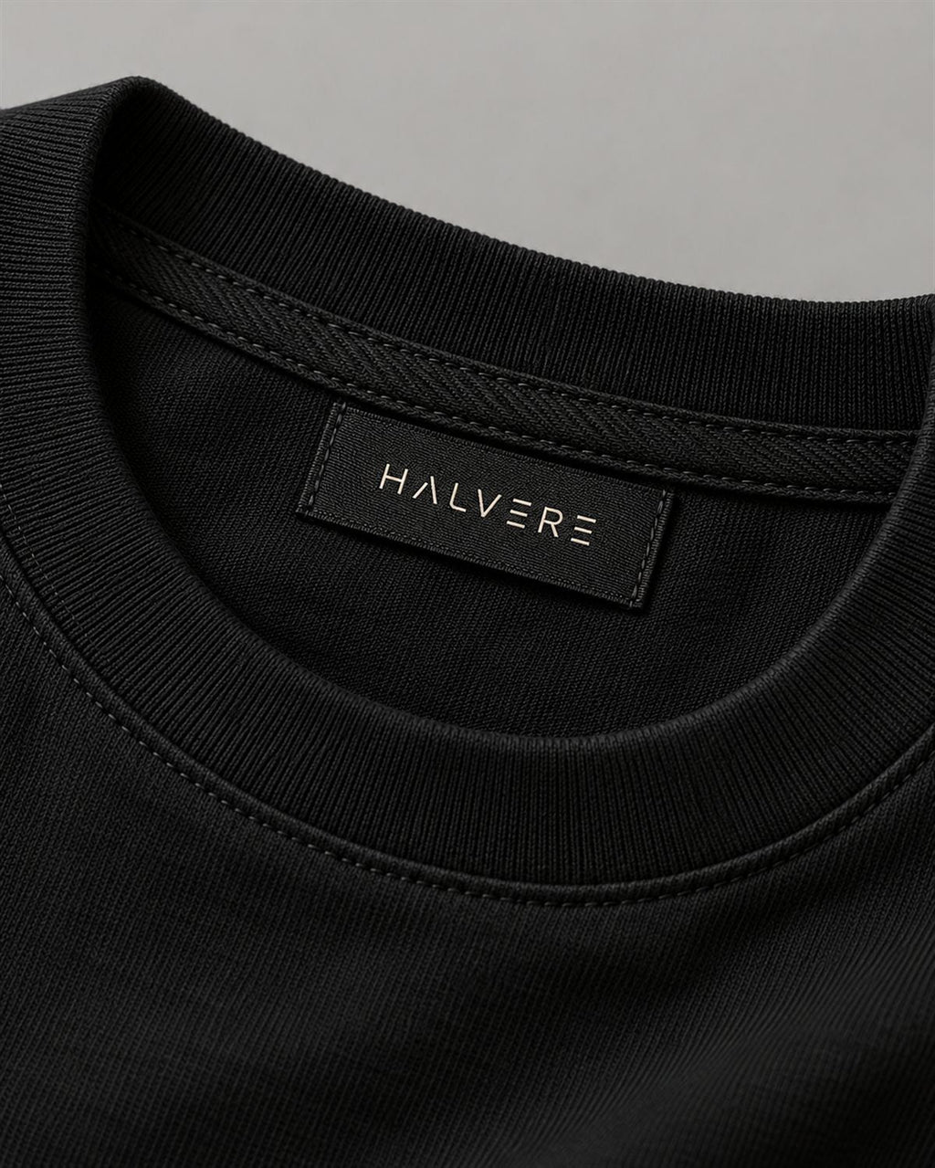 Woven HALVERE neck label on the black tee